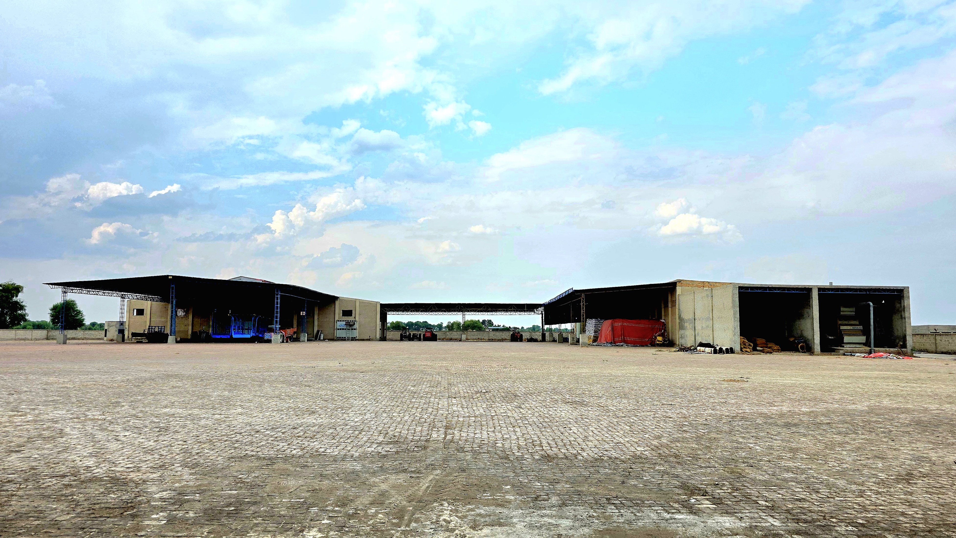 Exterior view of the Avena Agro Foods facility and yard approach.