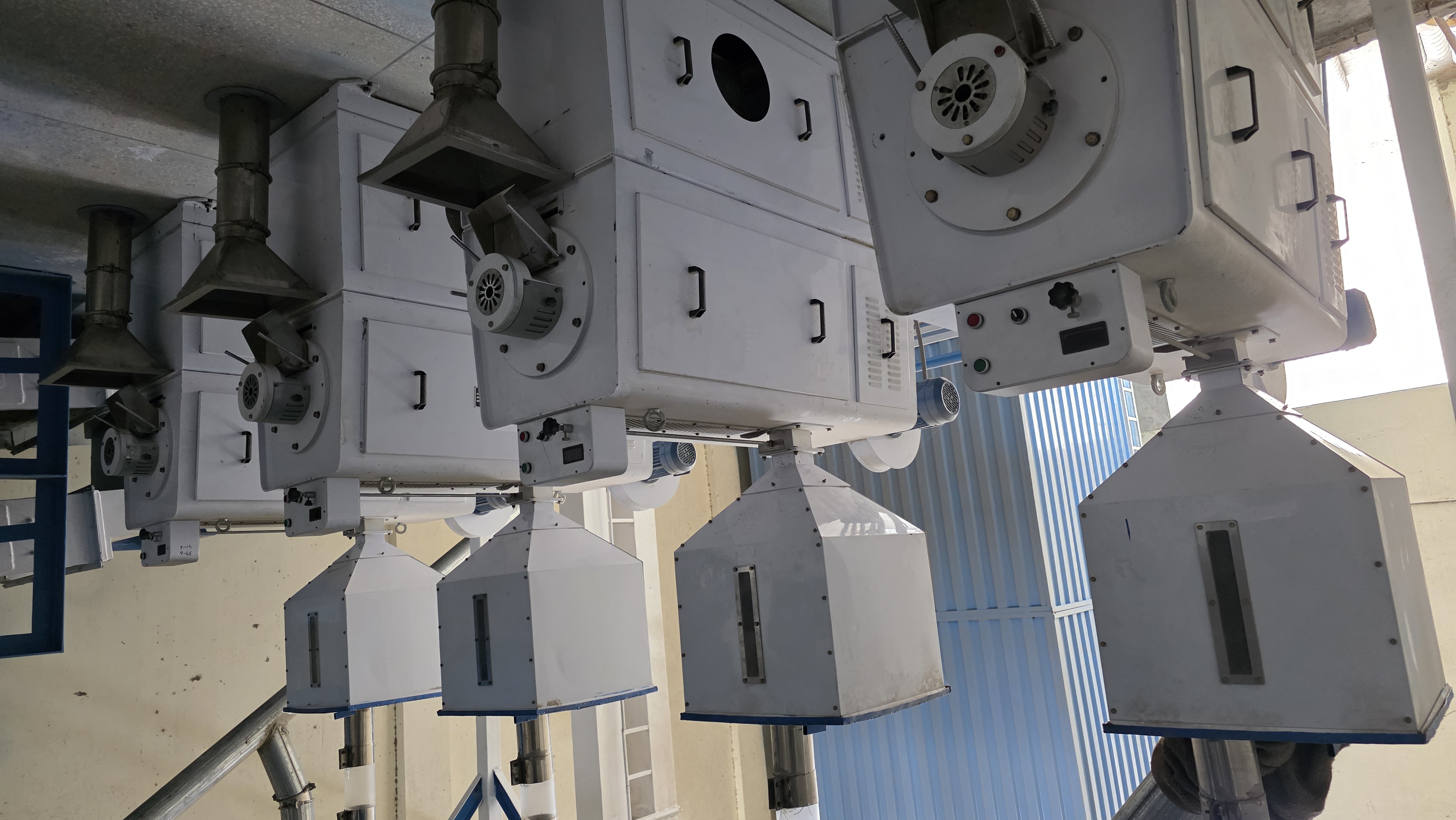 Paddy huskers supporting IRRI-9 Rice operational flow.